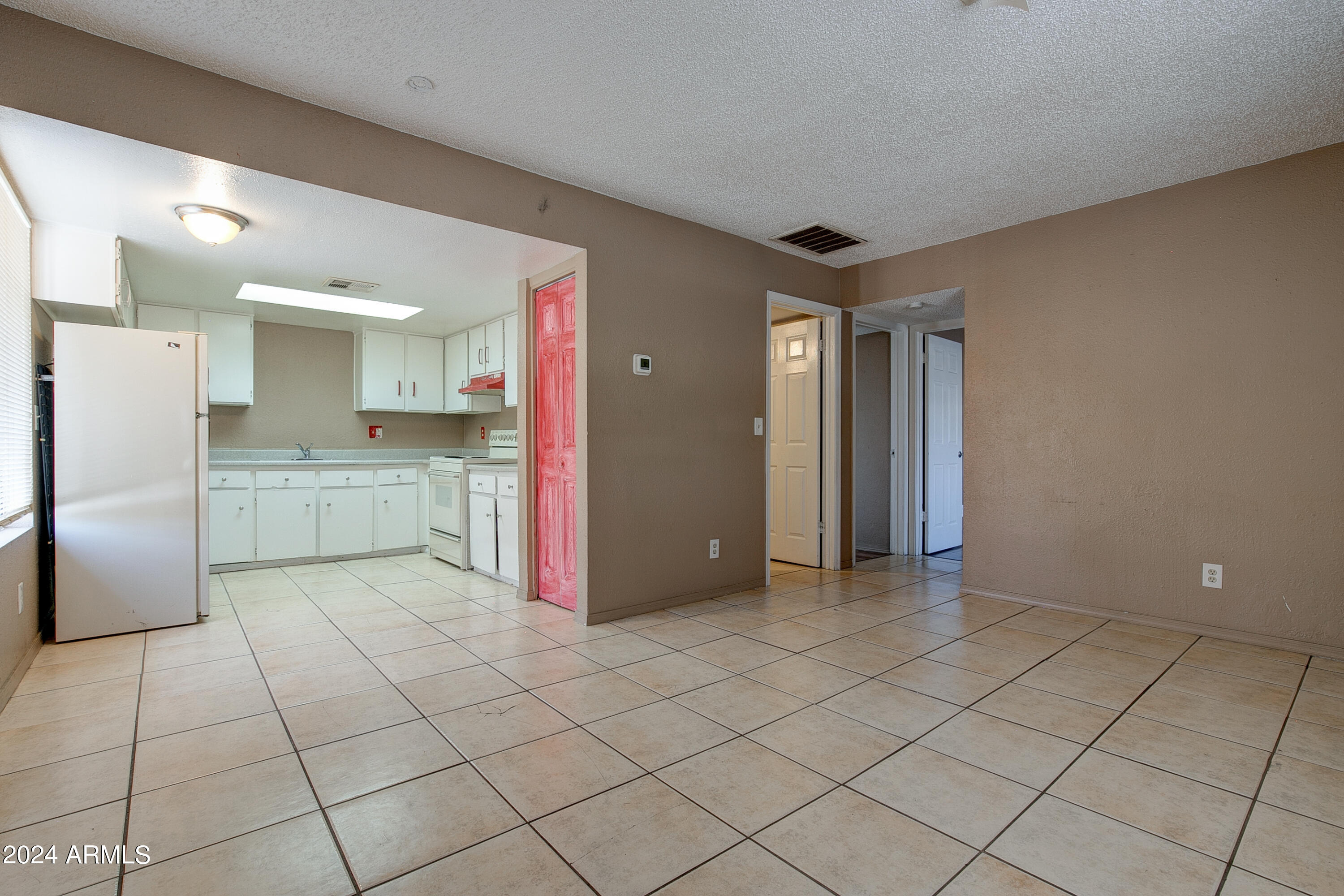 9631 North 12th Avenue, Unit 201 Phoenix, AZ 85021 - Photo 11 of 32 a view of a kitchen with a sink and a refrigerator
