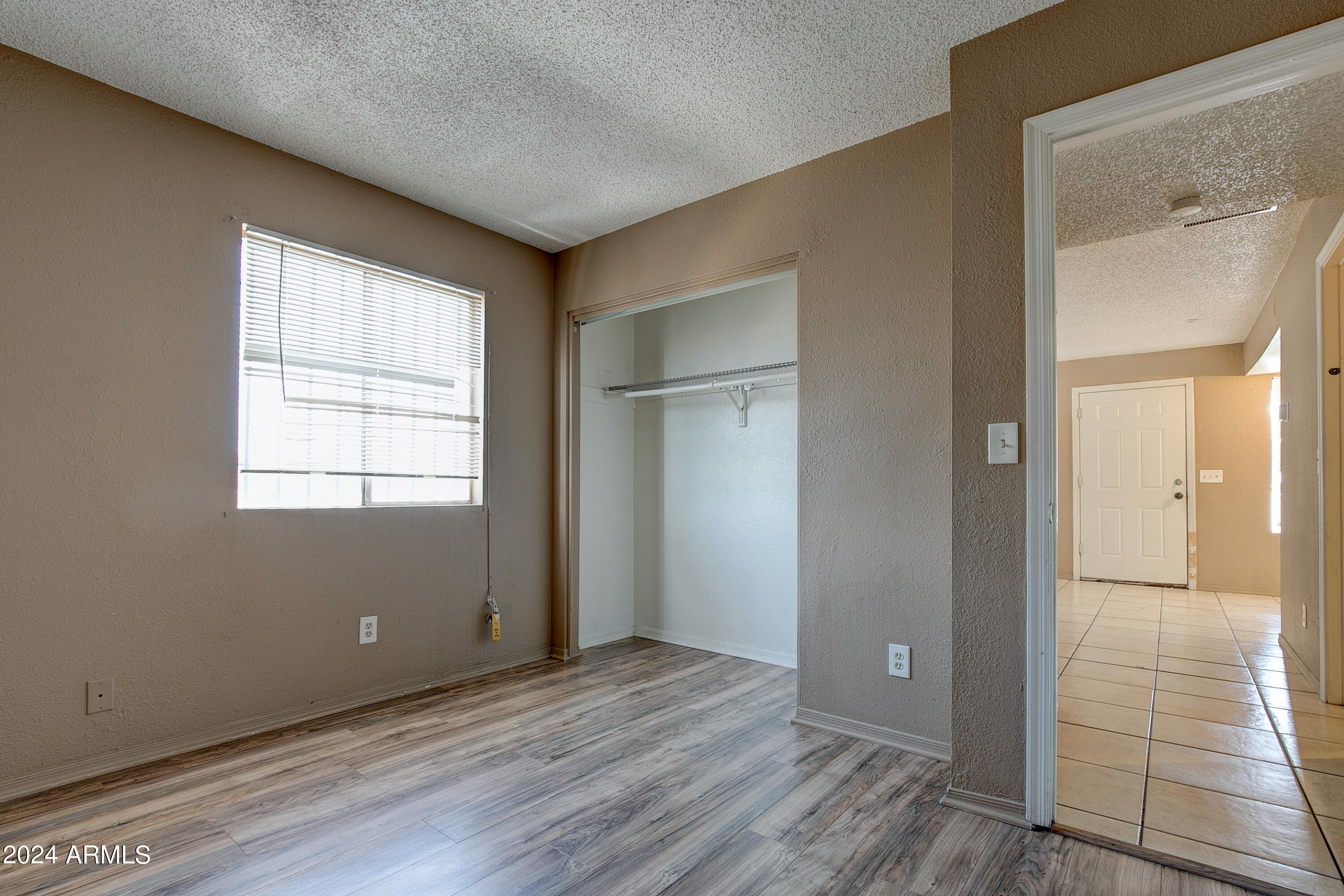9631 North 12th Avenue, Unit 201 Phoenix, AZ 85021 - Photo 16 of 32 an empty room with wooden floor and a window