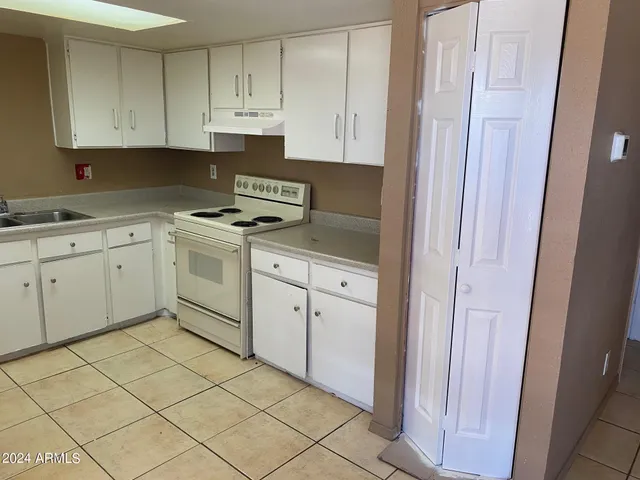 a kitchen with cabinets and appliances