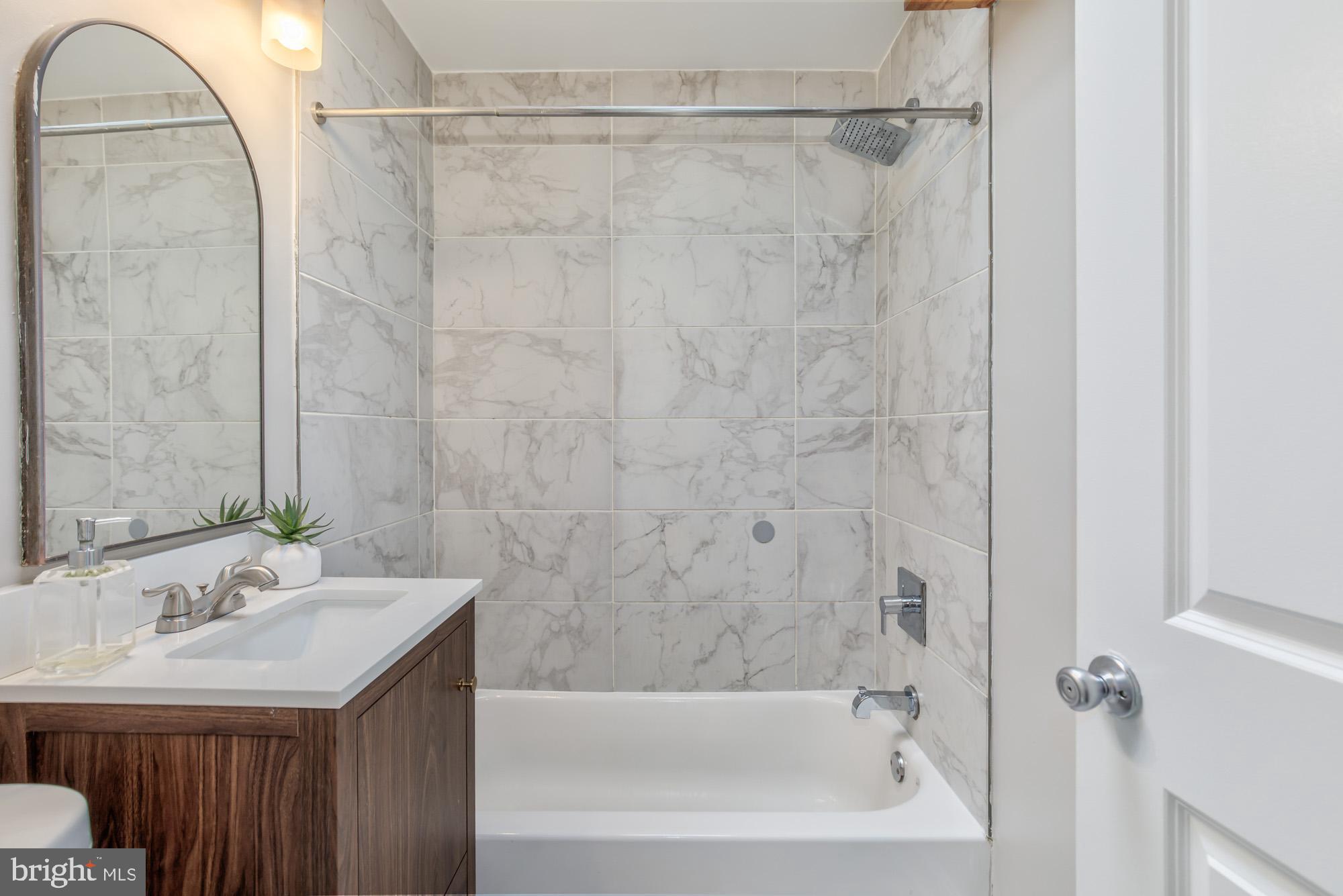 4003 Ames Street Northeast Washington, DC 20019 - Photo 30 of 44 Modern bathroom with elegant marble tiles.