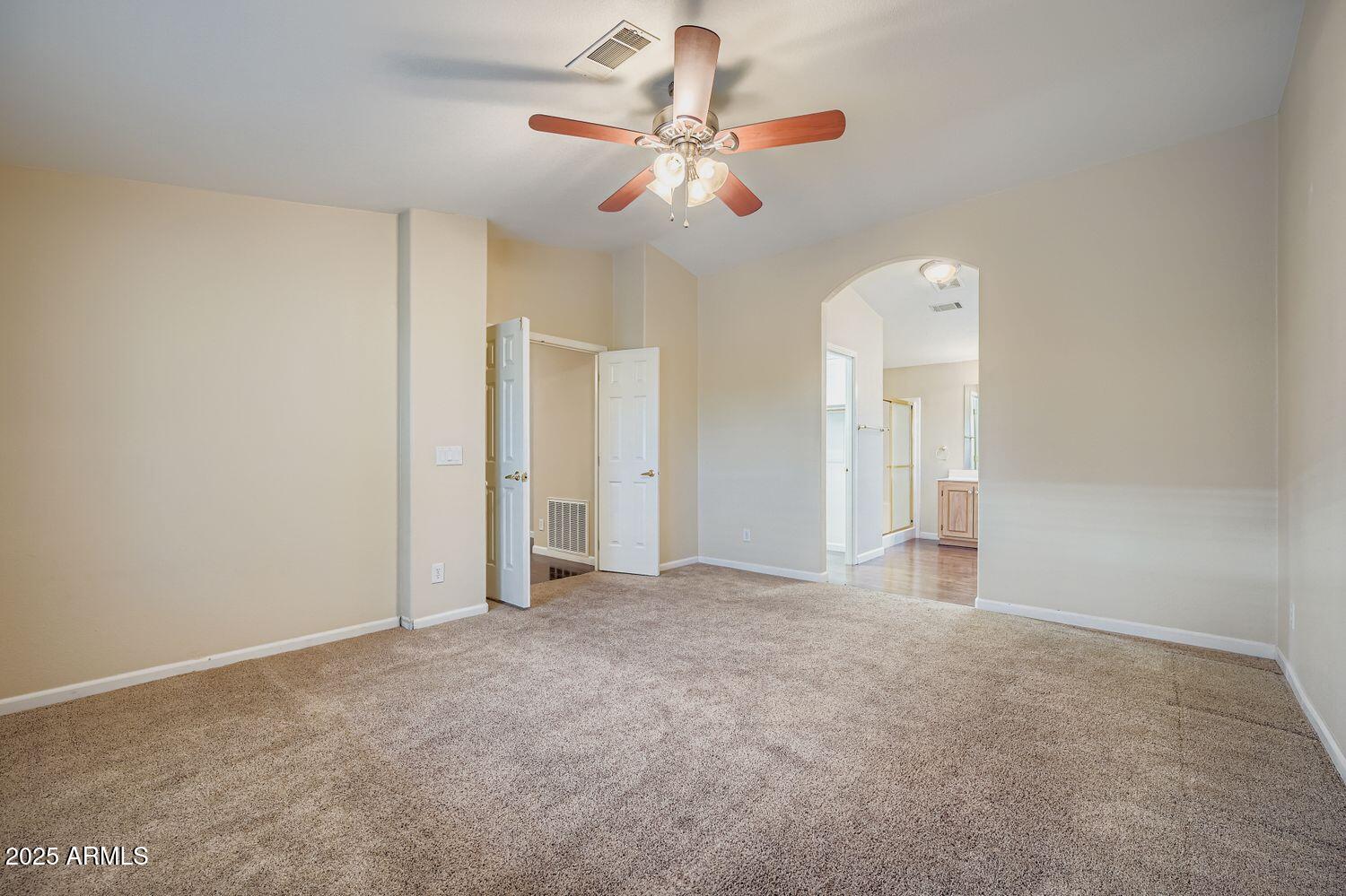 2550 South Ellsworth Road, Unit 277 Mesa, AZ 85209 - Photo 12 of 20 an empty room with chandelier fan