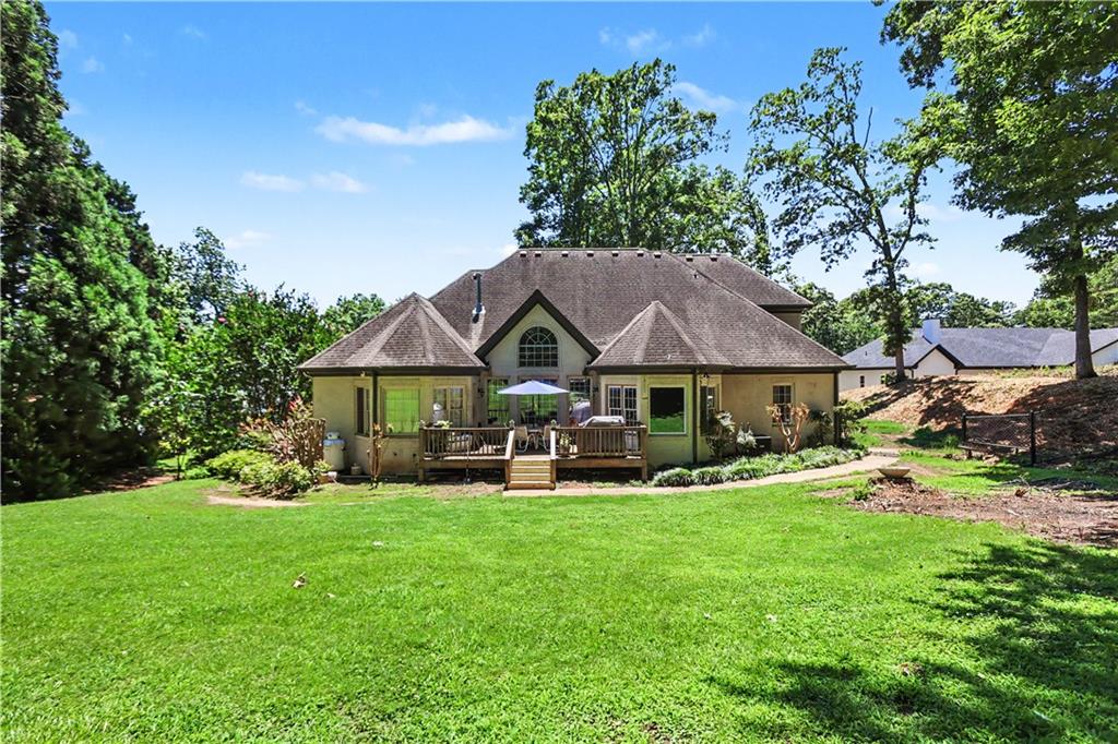 537 Old Collins Road Hoschton, GA 30548 - Photo 36 of 42 a view of a house with backyard garden and sitting area