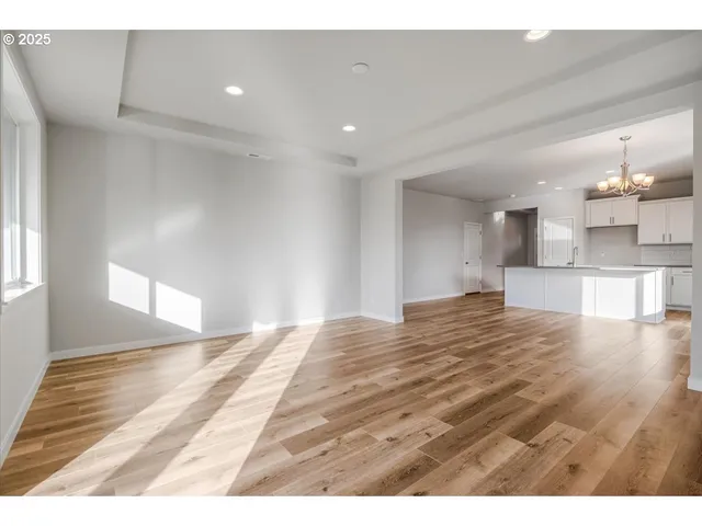a view of an empty room with a ceiling fan and window