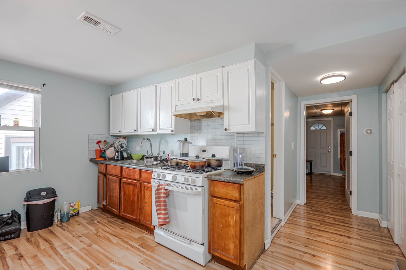 4910 West Walton Street Chicago, IL 60651 - Photo 14 of 27 a kitchen with stainless steel appliances granite countertop a stove and a refrigerator