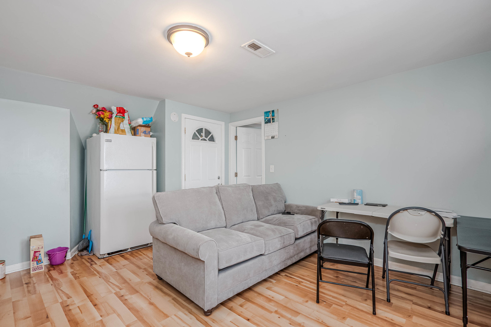4910 West Walton Street Chicago, IL 60651 - Photo 18 of 27 a living room with furniture and a wooden floor