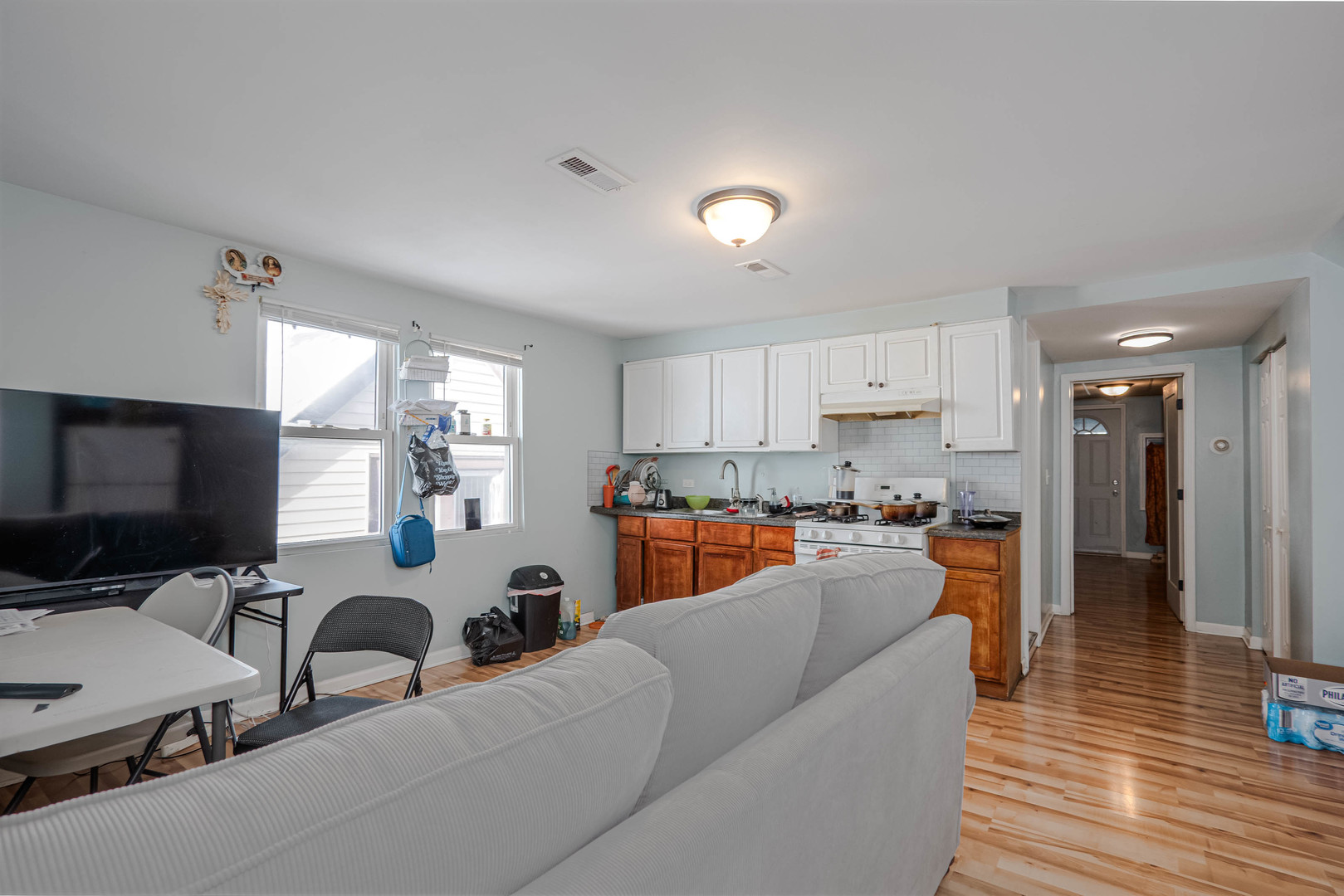 4910 West Walton Street Chicago, IL 60651 - Photo 19 of 27 a living room with furniture and a flat screen tv