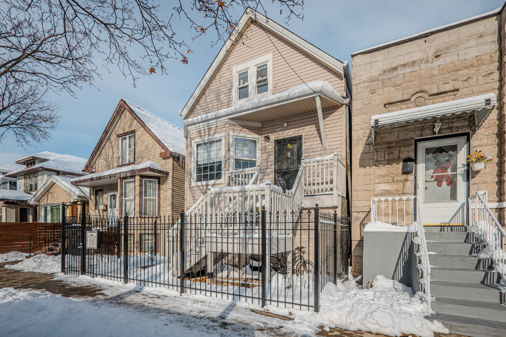 4910 West Walton Street Chicago, IL 60651 - Photo 2 of 27 a front view of a house with a porch