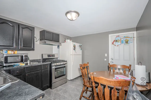 a living room with furniture and a ceiling fan