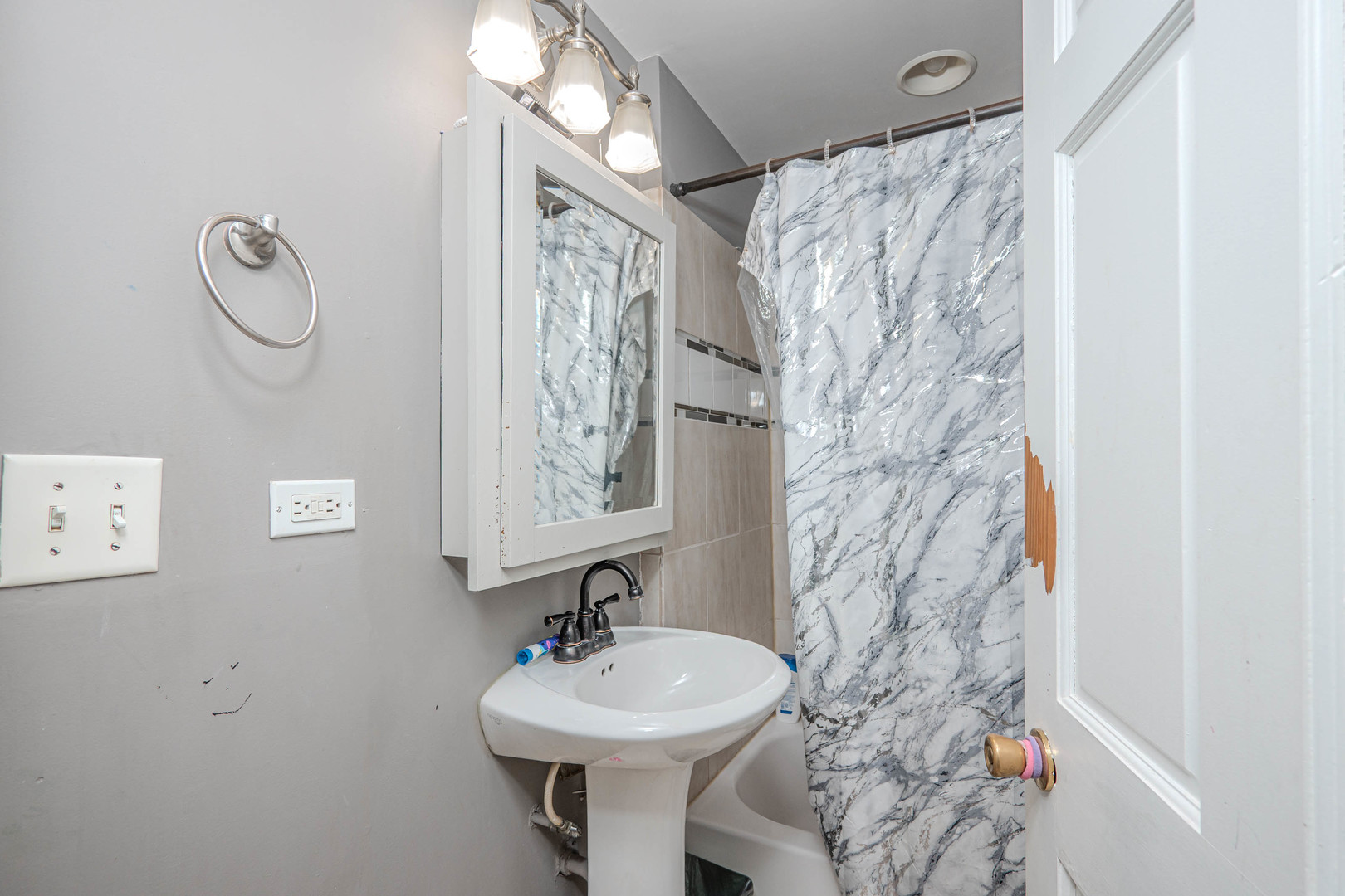 4910 West Walton Street Chicago, IL 60651 - Photo 24 of 27 a bathroom with a sink and mirror with toilet