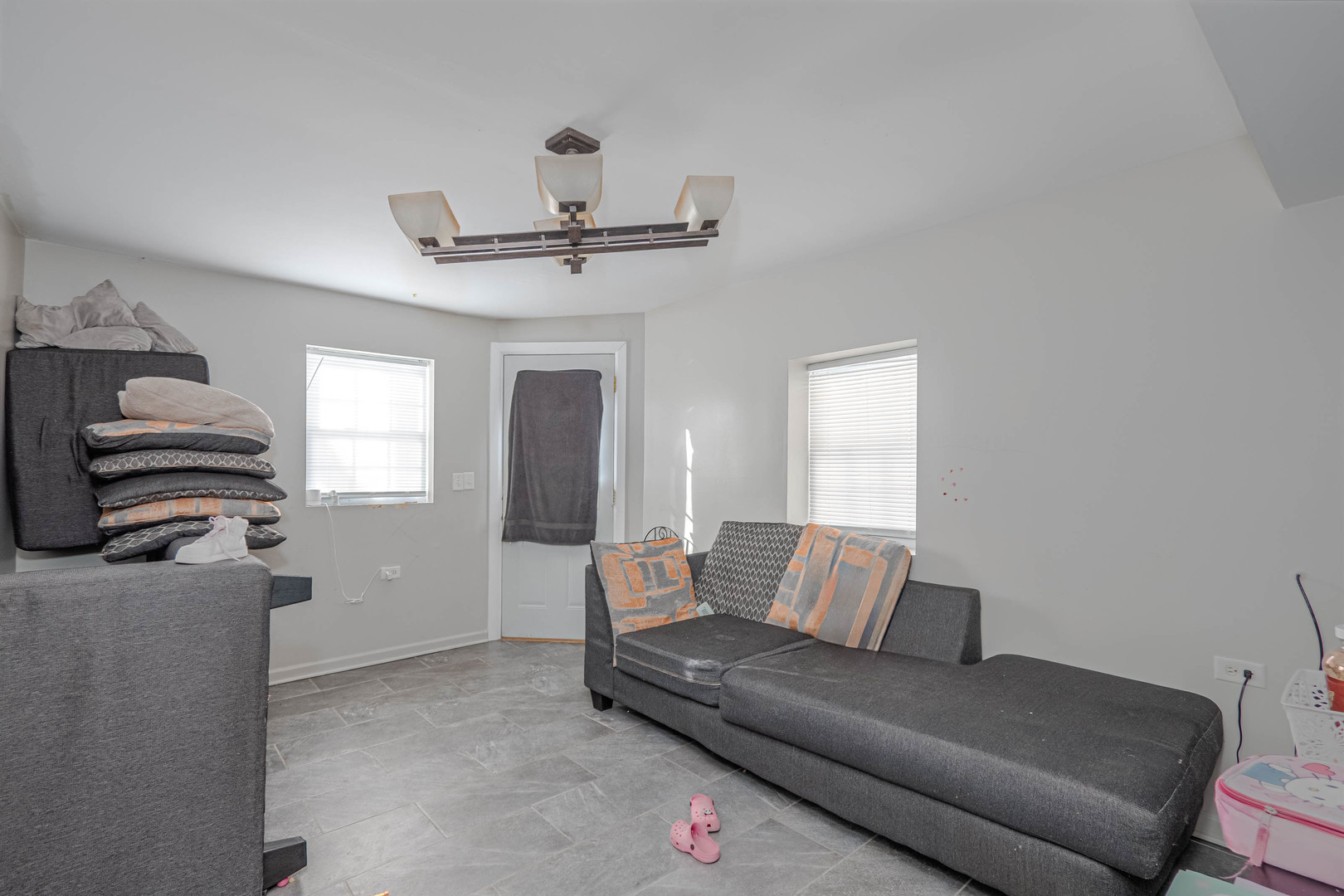 4910 West Walton Street Chicago, IL 60651 - Photo 25 of 27 a living room with furniture and a ceiling fan
