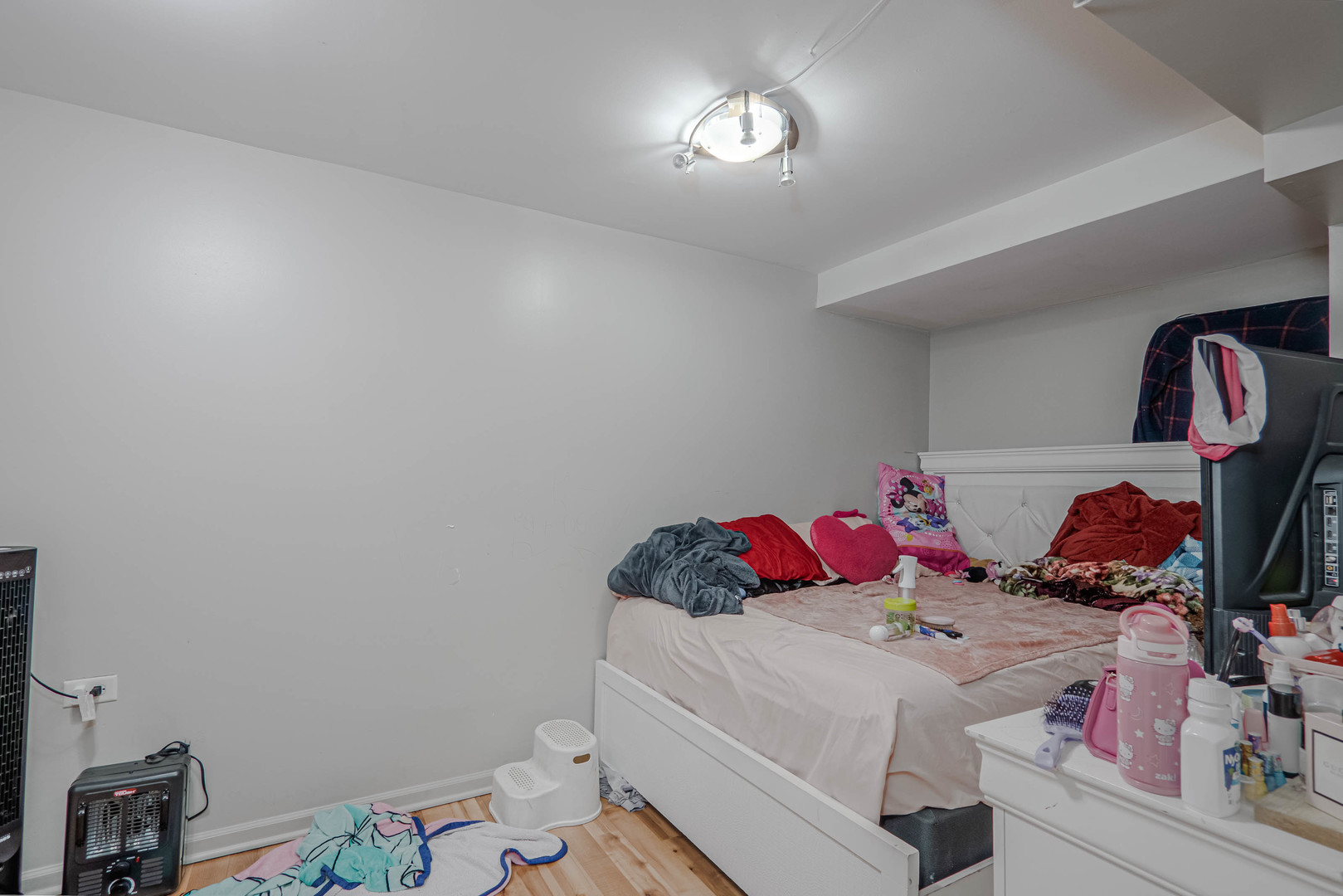 4910 West Walton Street Chicago, IL 60651 - Photo 26 of 27 a bedroom with a bed and a chandelier