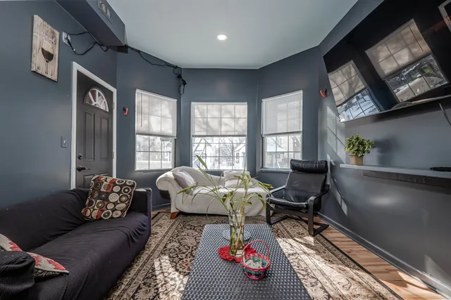 a living room with furniture and a floor to ceiling window