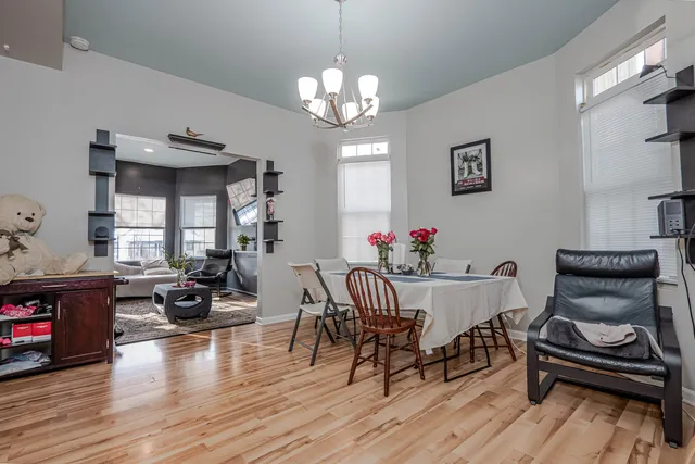 a view of a dining room with furniture wooden floor and a chandelier