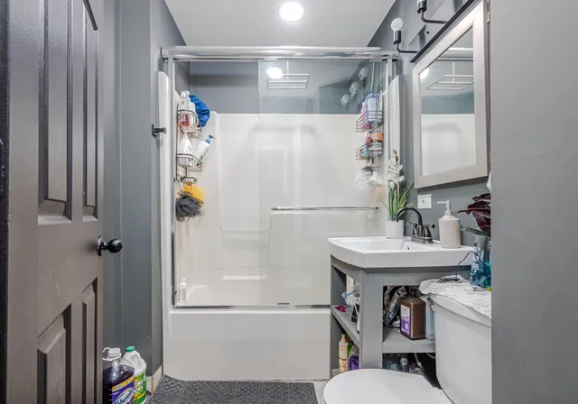 a bathroom with a sink toilet and shower