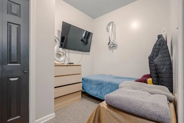 a bedroom with two beds and painted walls