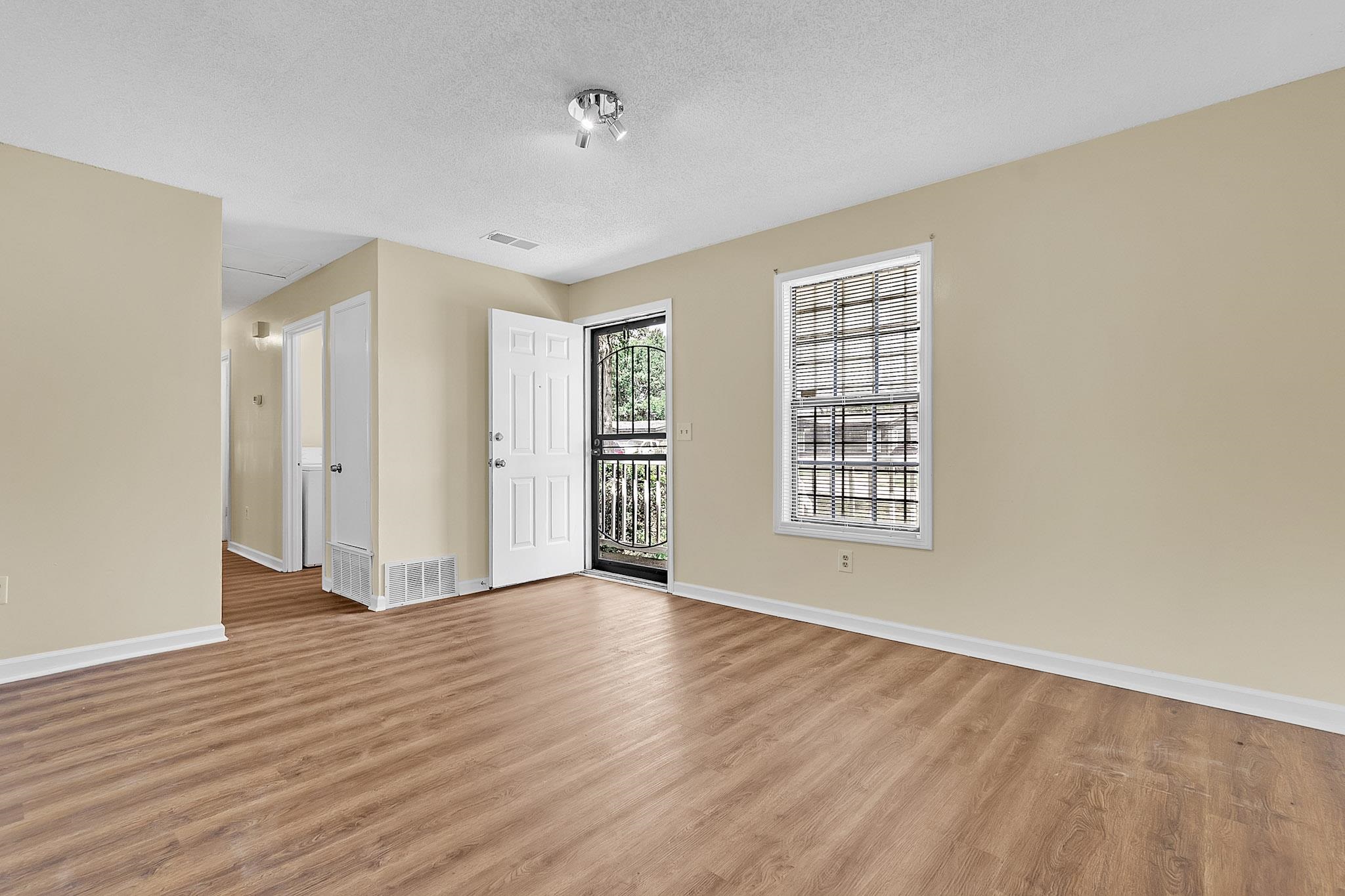 2955 Lake Park Road Memphis, TN 38127 - Photo 11 of 26 a view of an empty room with wooden floor and a window