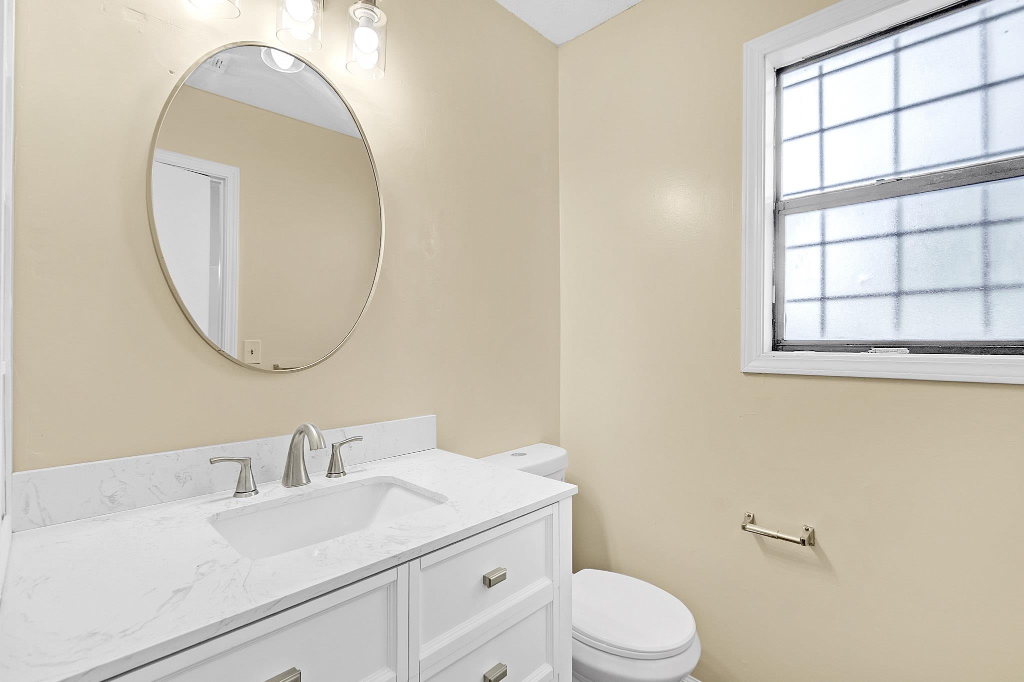 2955 Lake Park Road Memphis, TN 38127 - Photo 15 of 26 a bathroom with a sink a toilet and a mirror