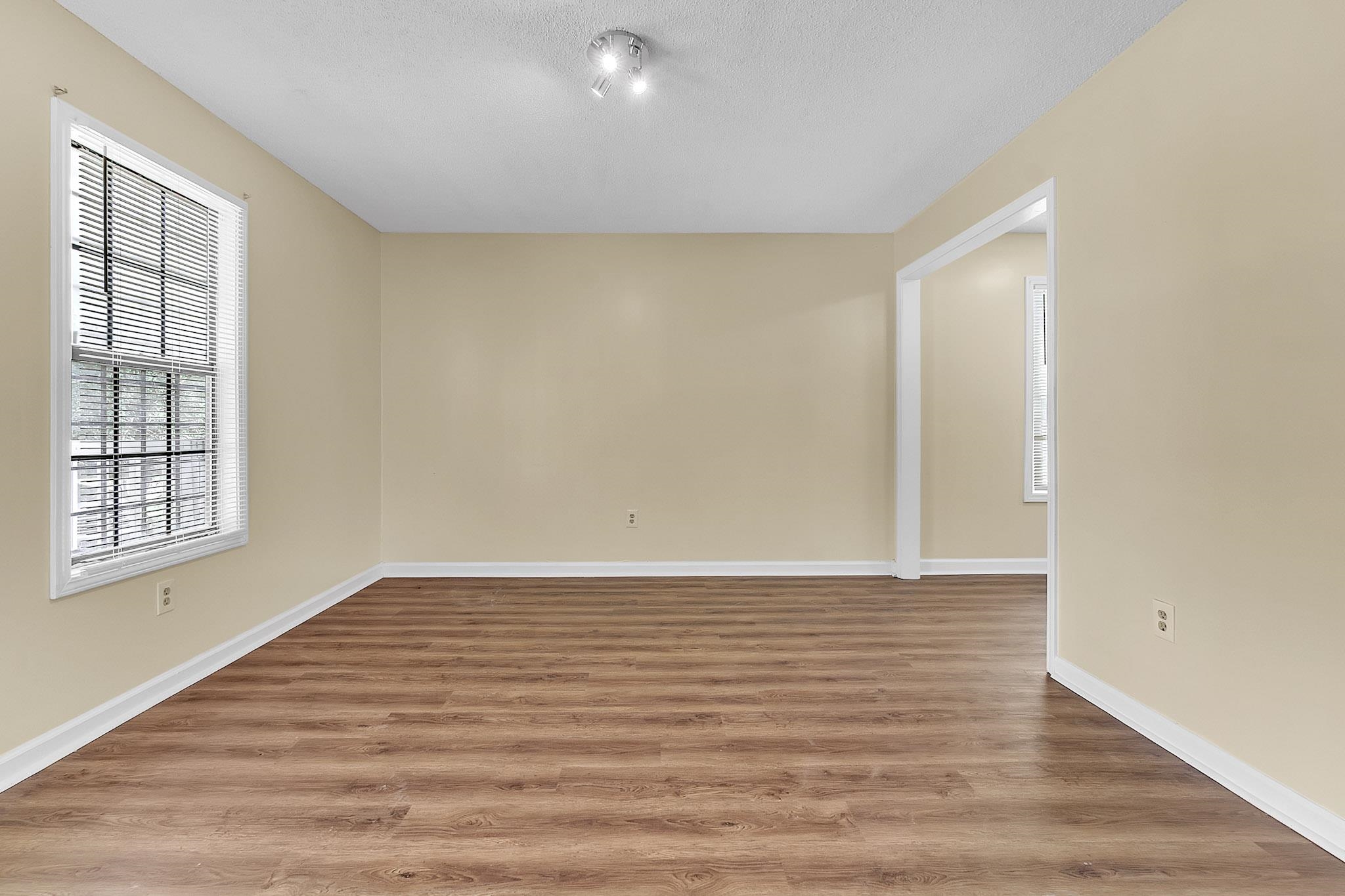 2955 Lake Park Road Memphis, TN 38127 - Photo 5 of 26 a view of an empty room with wooden floor and a window