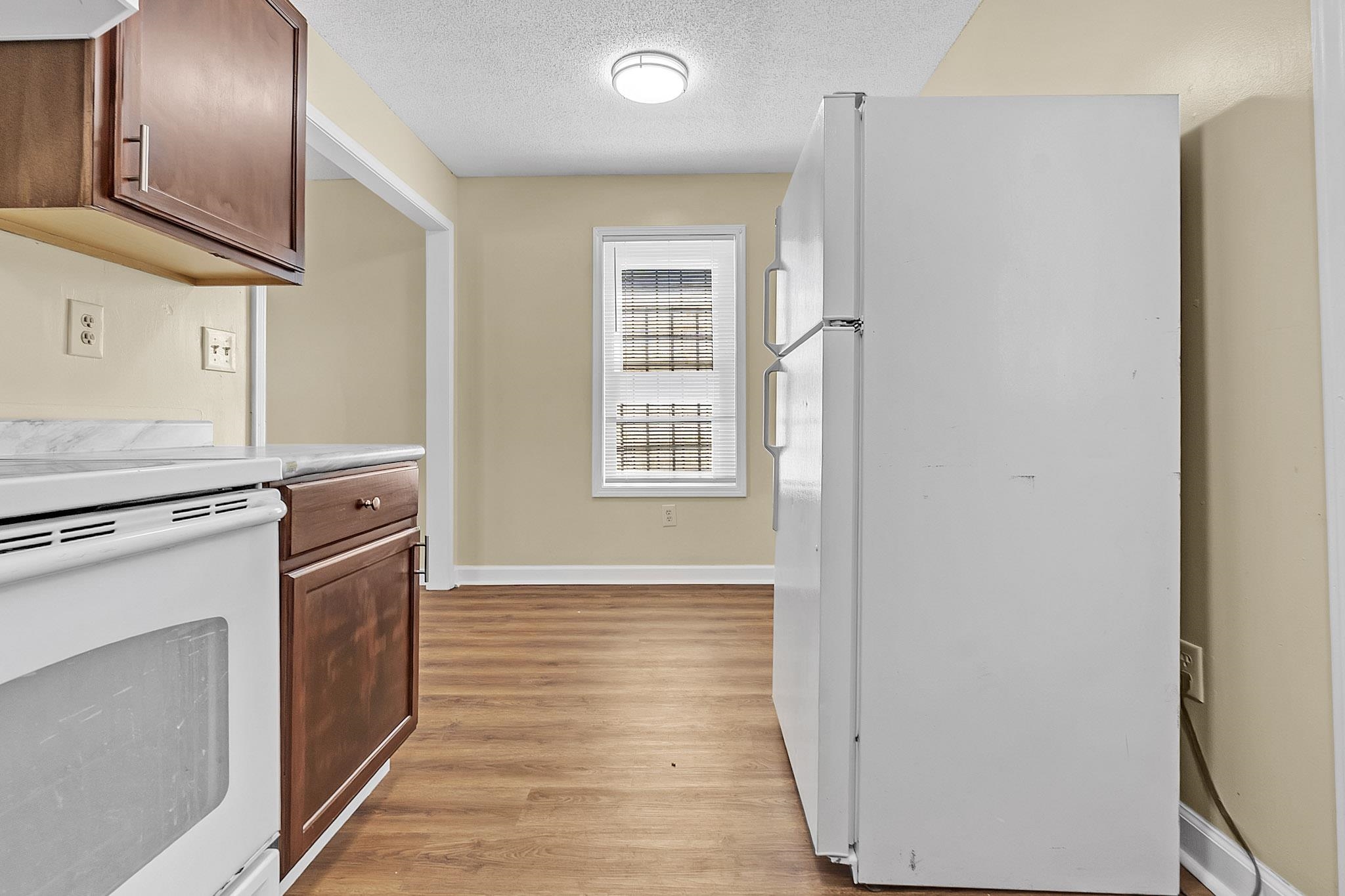 2955 Lake Park Road Memphis, TN 38127 - Photo 8 of 26 a kitchen with granite countertop a stove and a refrigerator