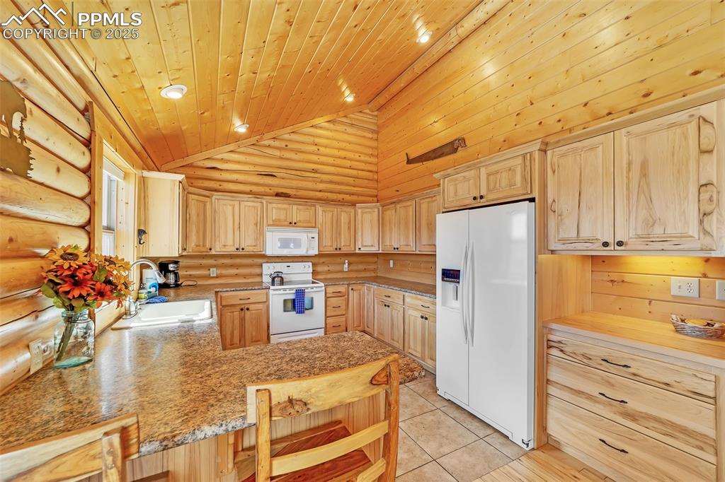 17549 Highway 67 Divide, CO 80814 - Photo 15 of 46 a kitchen with refrigerator and cabinets