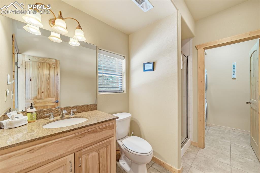 17549 Highway 67 Divide, CO 80814 - Photo 25 of 46 a bathroom with a granite countertop sink toilet and shower