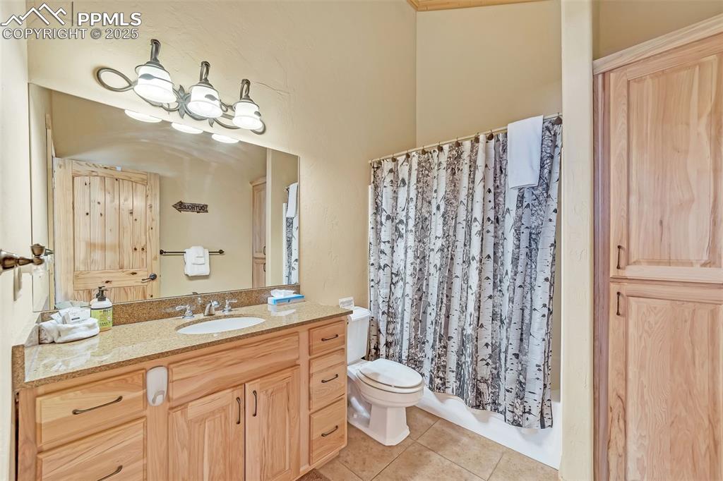17549 Highway 67 Divide, CO 80814 - Photo 28 of 46 a bathroom with a double vanity sink mirror and toilet