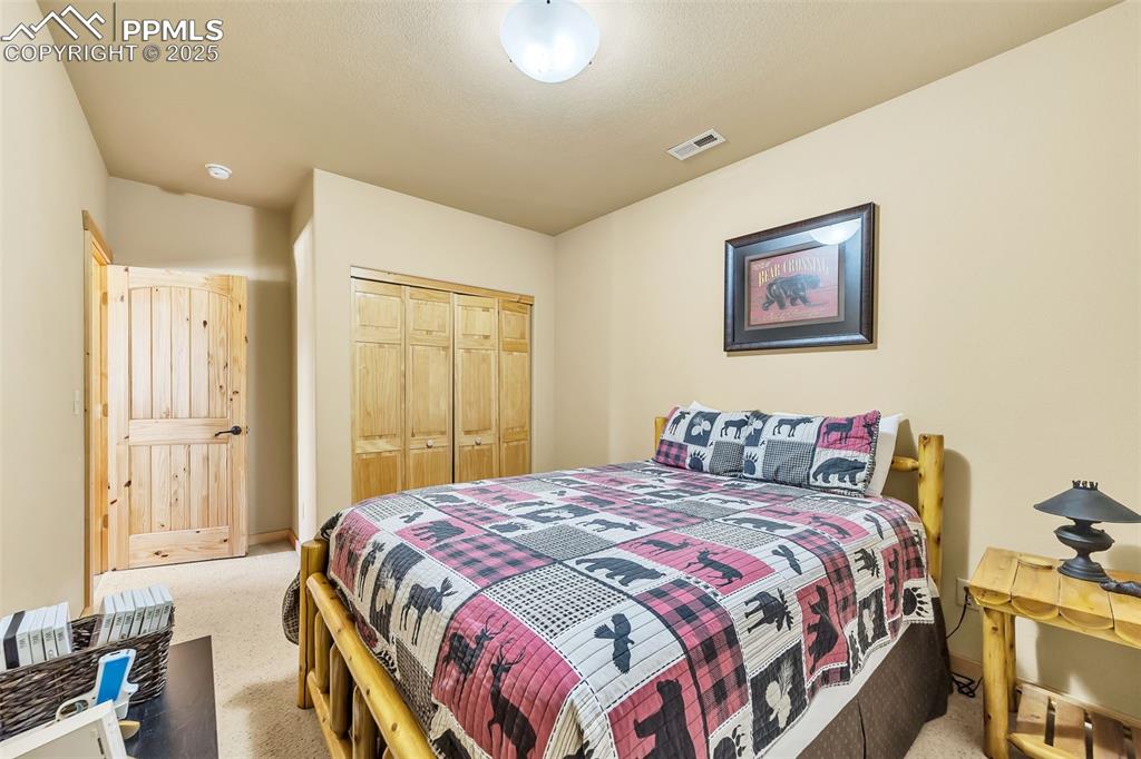 17549 Highway 67 Divide, CO 80814 - Photo 31 of 46 a bedroom with a bed and a painting on the wall