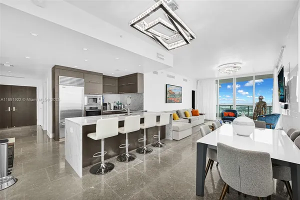 a view of kitchen with dining area refrigerator and wooden floor