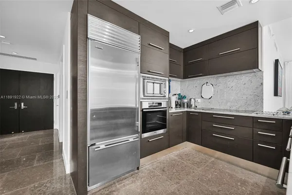 a kitchen with granite countertop stainless steel appliances and wooden cabinets