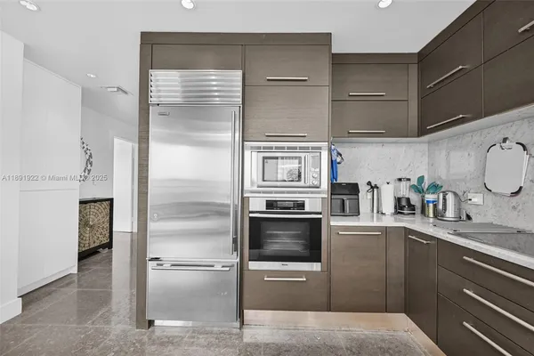 a kitchen with a refrigerator and a sink