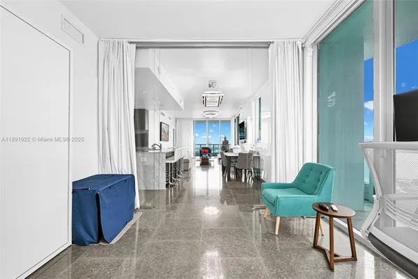 a living room with furniture a dining table and a large window