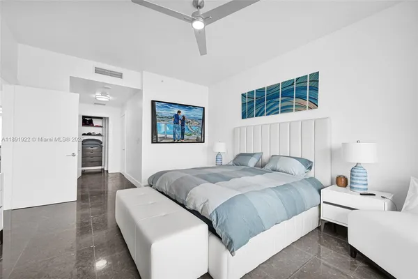 a bedroom with a bed couch and a window