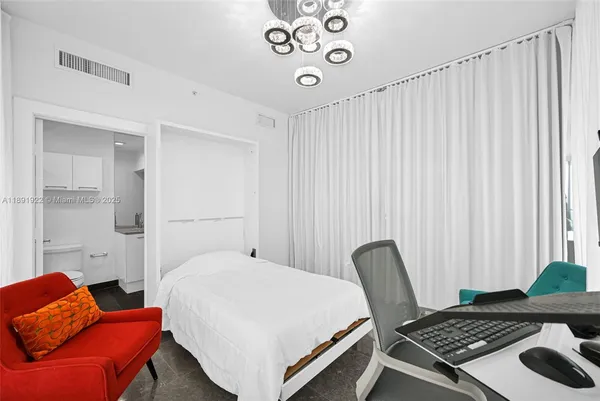 a bedroom with a bed and a chair