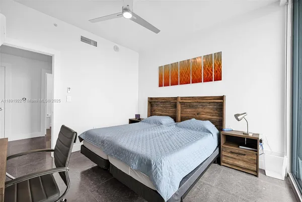 a bedroom with a bed and a chair