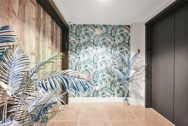 a view of a bedroom with a bed and chair