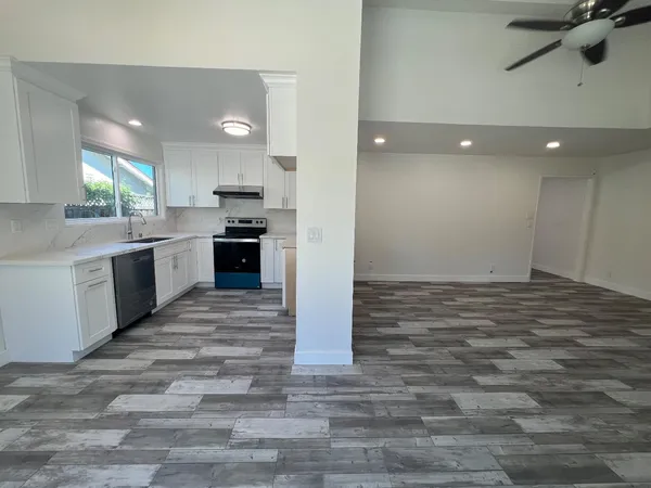 a view of a kitchen with a sink stainless steel appliances and cabinets