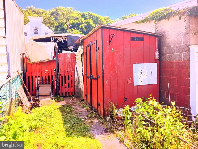 a view of a house with backyard and wooden fence