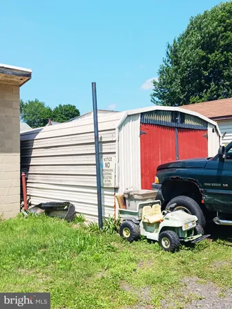 a view of backyard with a car parked