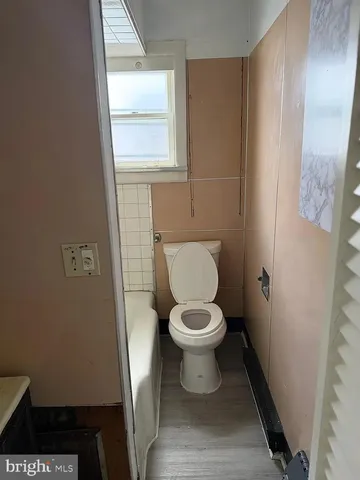 a white toilet sitting next to a window