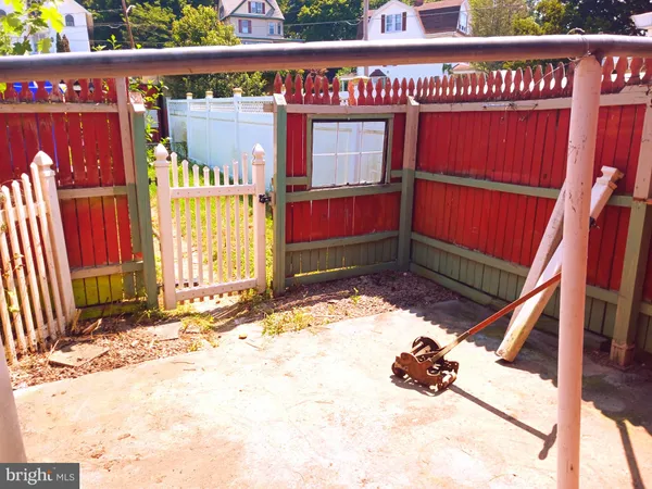 a view of outdoor space with wooden floor and a bench