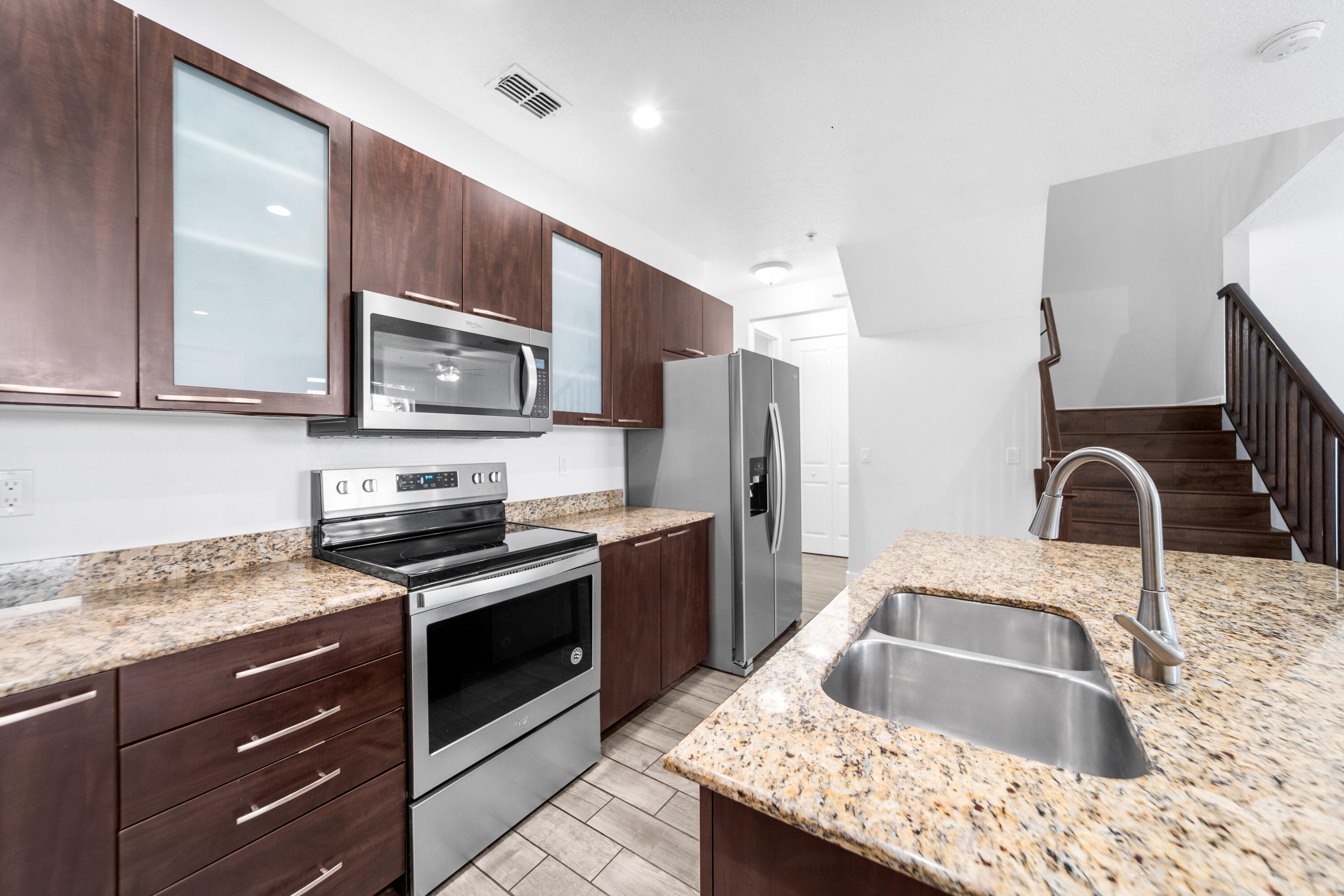 1430 Northwest 48th Lane Boca Raton, FL 33431 - Photo 11 of 54 a kitchen with stainless steel appliances granite countertop a sink stove and refrigerator