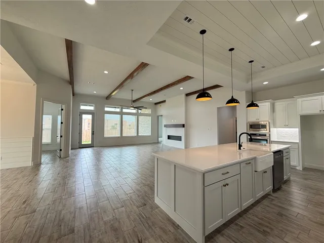 a view of a livingroom with a ceiling fan and window