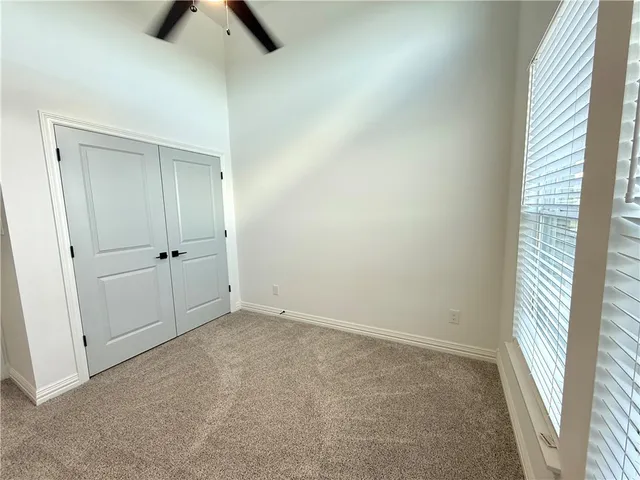 a bathroom with a granite countertop tub a double vanity sink and a large mirror