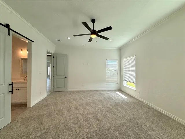 a spacious bathroom with a granite countertop sink mirror and a toilet