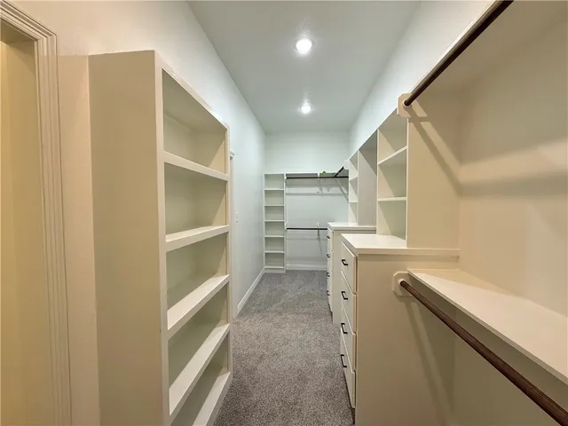 an empty room with a window and a ceiling fan