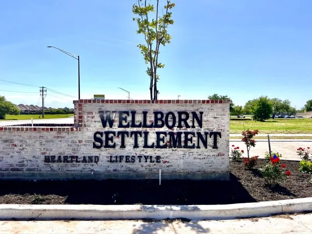 a view of a hallway with wooden floor and a window