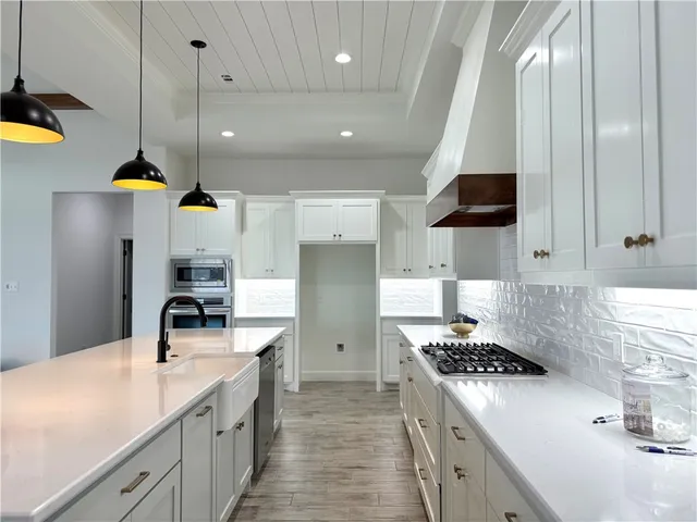 a kitchen with a sink and a stove top oven
