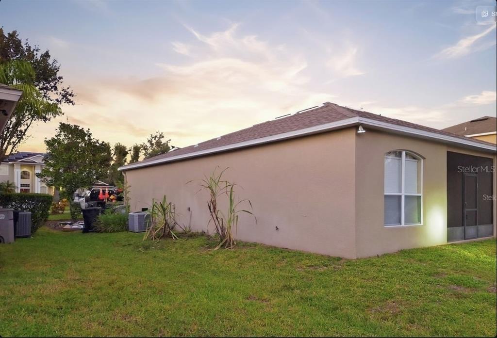 2056 Clapper Trail Apopka, FL 32703 - Photo 14 of 14 a backyard of a house with lots of green space and trampoline