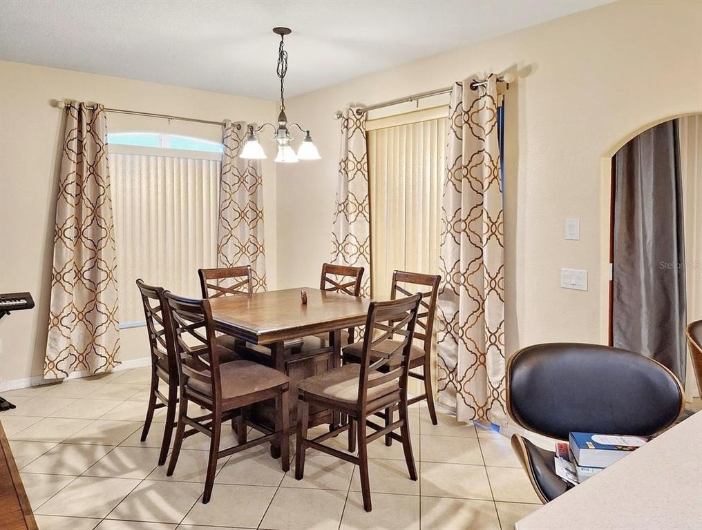 2056 Clapper Trail Apopka, FL 32703 - Photo 9 of 14 a view of a dining room with furniture and window