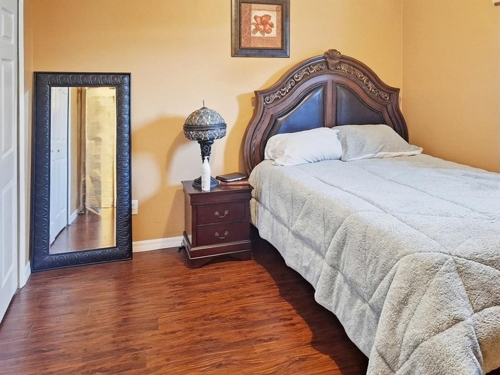 2056 Clapper Trail Apopka, FL 32703 - Photo 10 of 14 a spacious bedroom with a bed and wooden floor